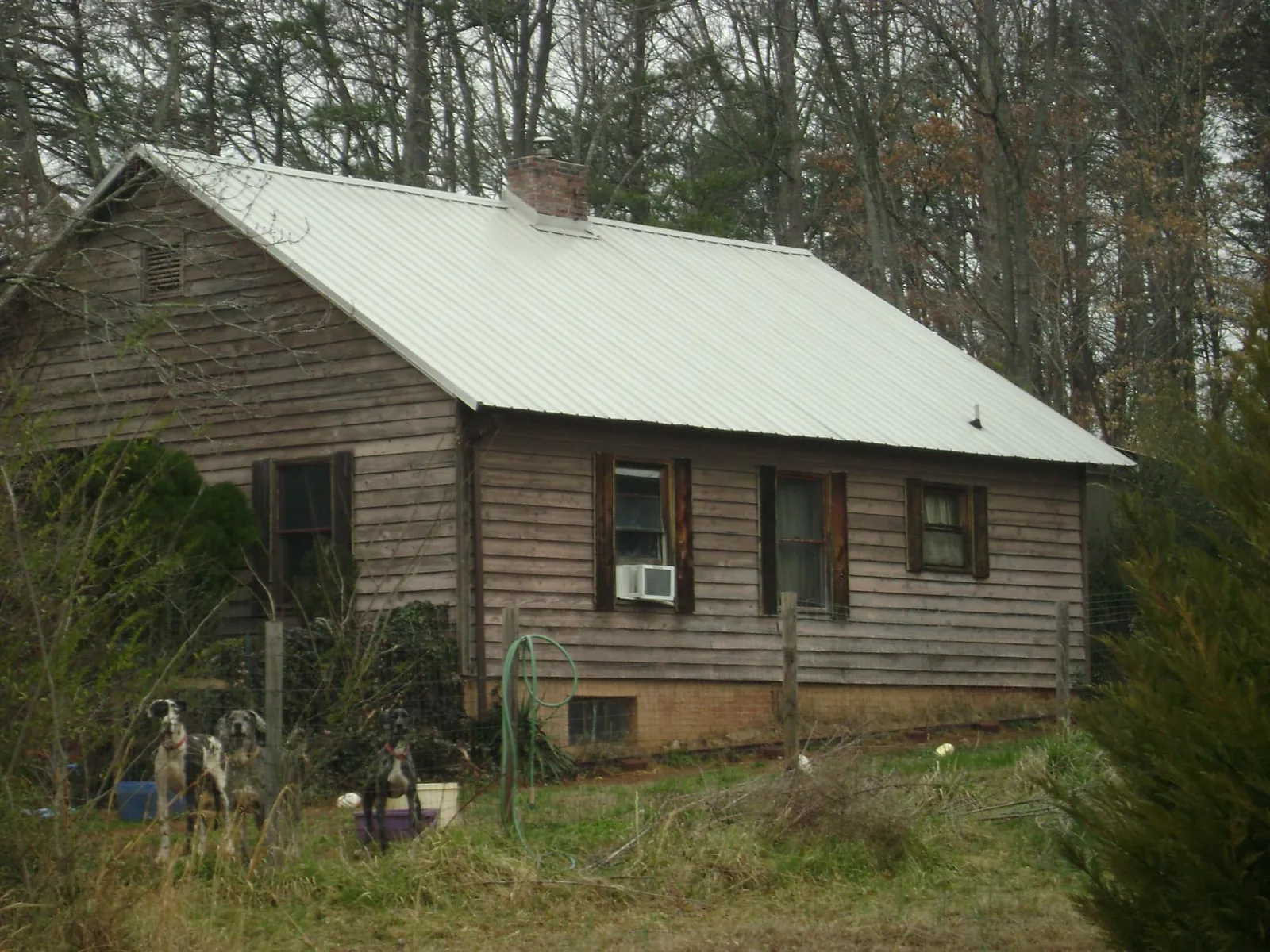 White metal roof on an old wood sided farmhouse, from a Metal Roof Installation job in Belle Mead
